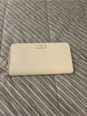 kate spade cream leather zip-around wallet with gold plaque